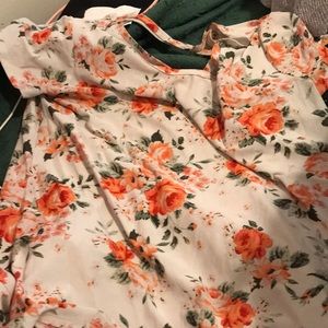White flowery dress shirt with an X in the back